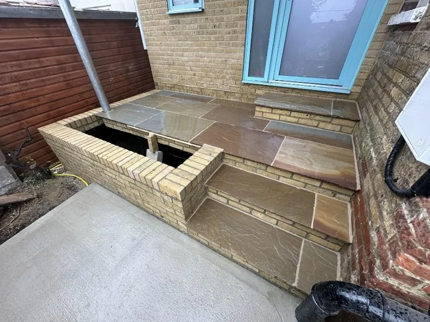 Brick steps with raised planter in Bromley